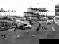 Archive image c1960s of race cars on track with drivers running to their cars
