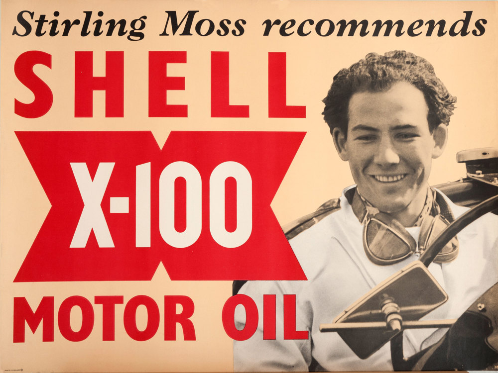 Shell poster number 1538, Stirling Moss Recommends Shell (1952) by Shell Studio. Photograph of Stirling Moss with the text: "Stirling Moss recommends Shell X-100 Motor Oil." The new lubricant X-100 was devised and launched by Shell in 1949 to help to reintroduce the Shell name back into Britain after the war, after oil companies had pooled their resources.