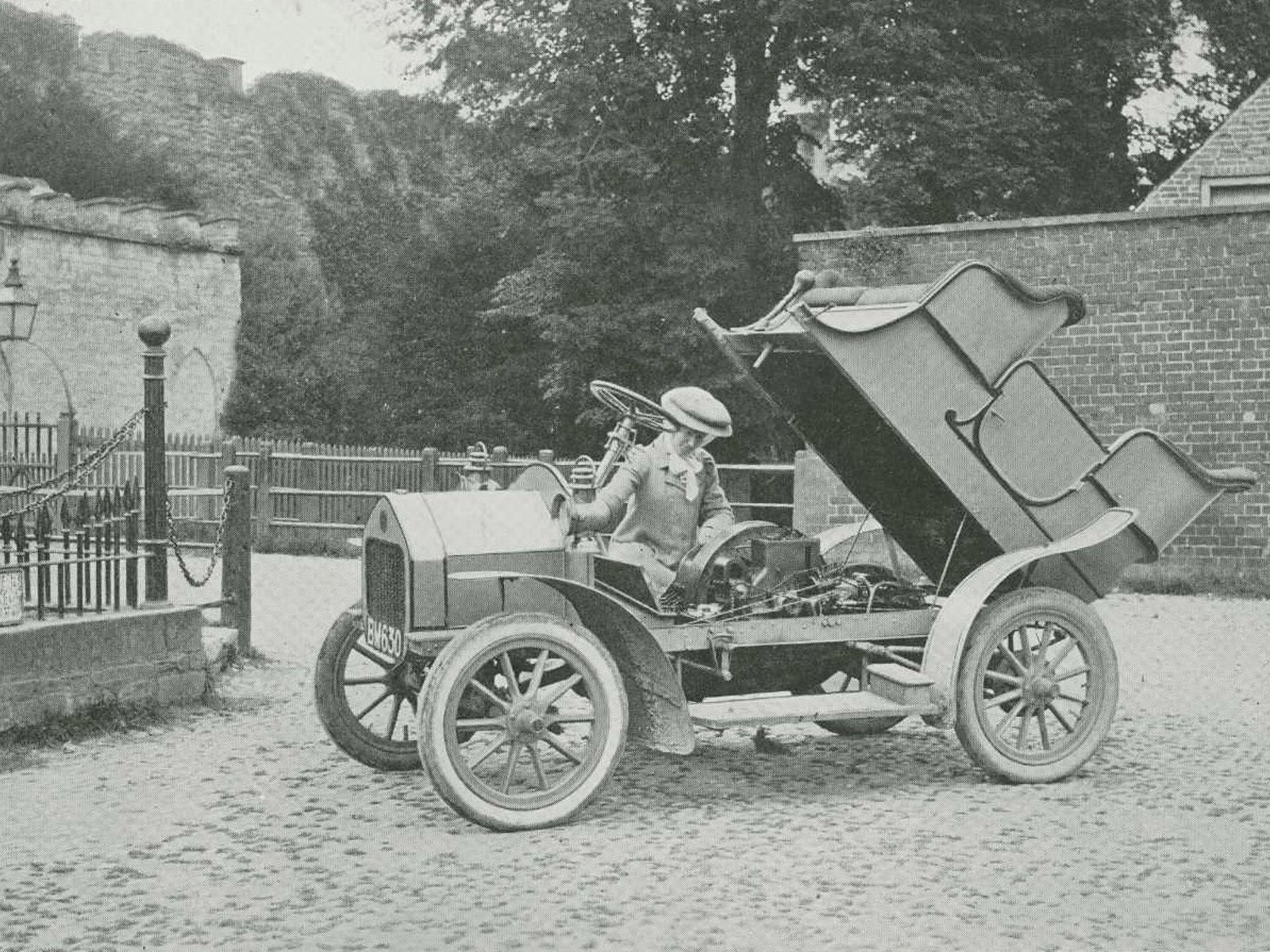 Woman working under the bonnet of a car