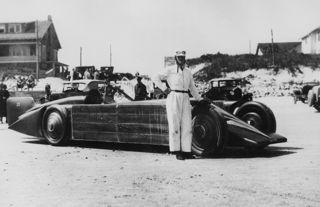 Henry Segrave standing in front of Golden Arrow, Daytona 1929