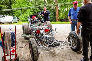 Allard Chrysler Dragster with driver and men talking around it