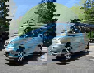 Light blue 2004 Citroen Xsara Picasso from the Gavin and Stacey TV series. Pictured near to the monorail at the National Motor Museum with a green dome in the background.