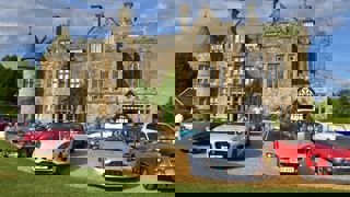 Cars lined up outside Palace House, Beaulieu, for a B100 Members day