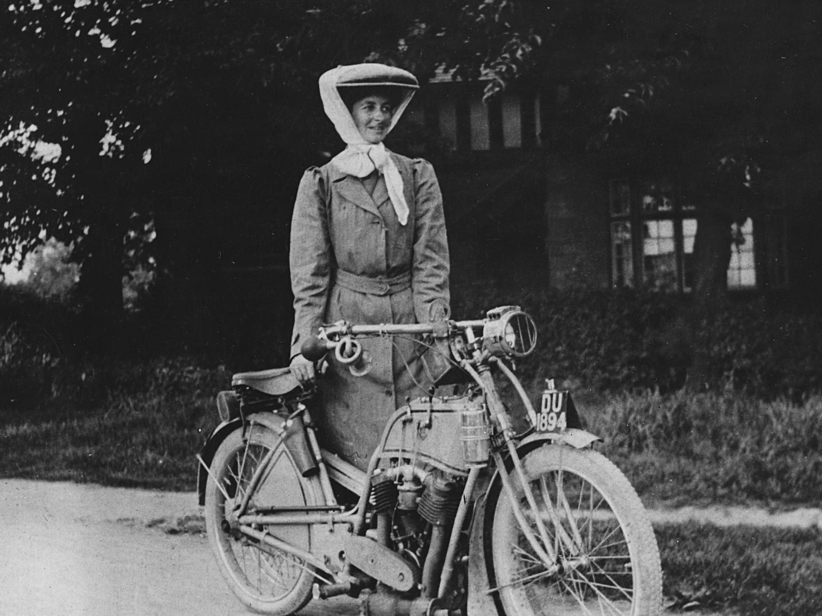 Miss Muriel Hind standing by her Rex motorcycle in 1909