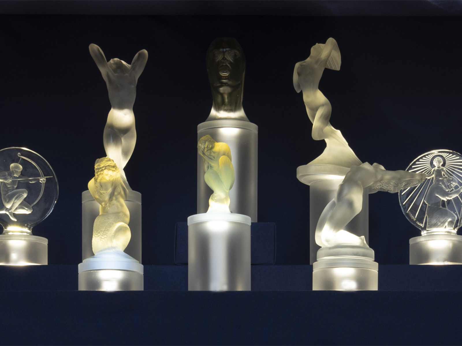 Lalique glass mascots in display case at the National Motor Museum