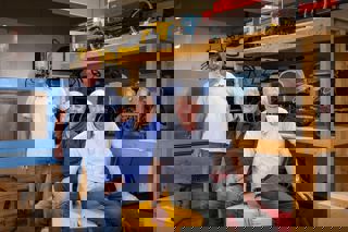 three male volunteers in objects store