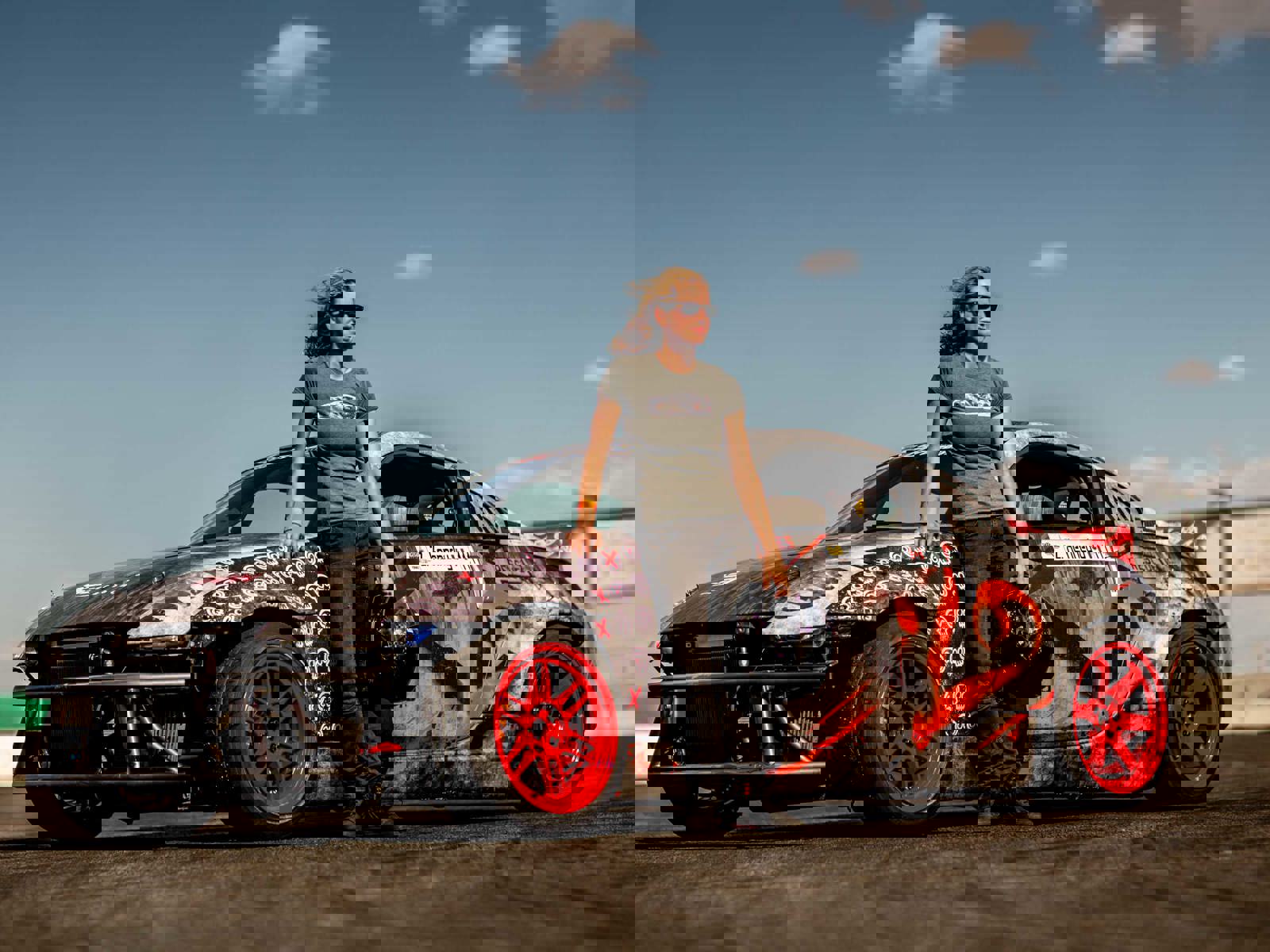 Zandara Kennedy standing next to racing car