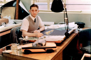 Ron Hickman sitting at his desk working as designer for Lotus