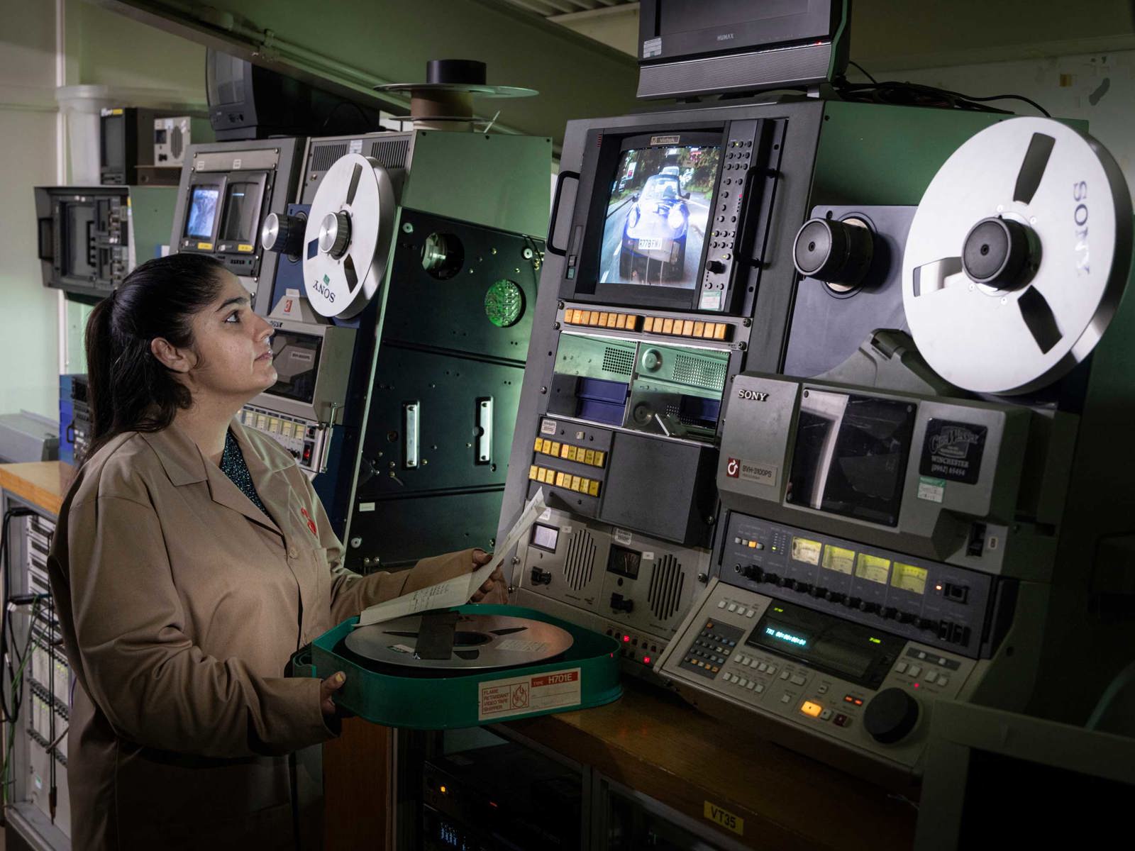 female member of staff working on a one inch video machine