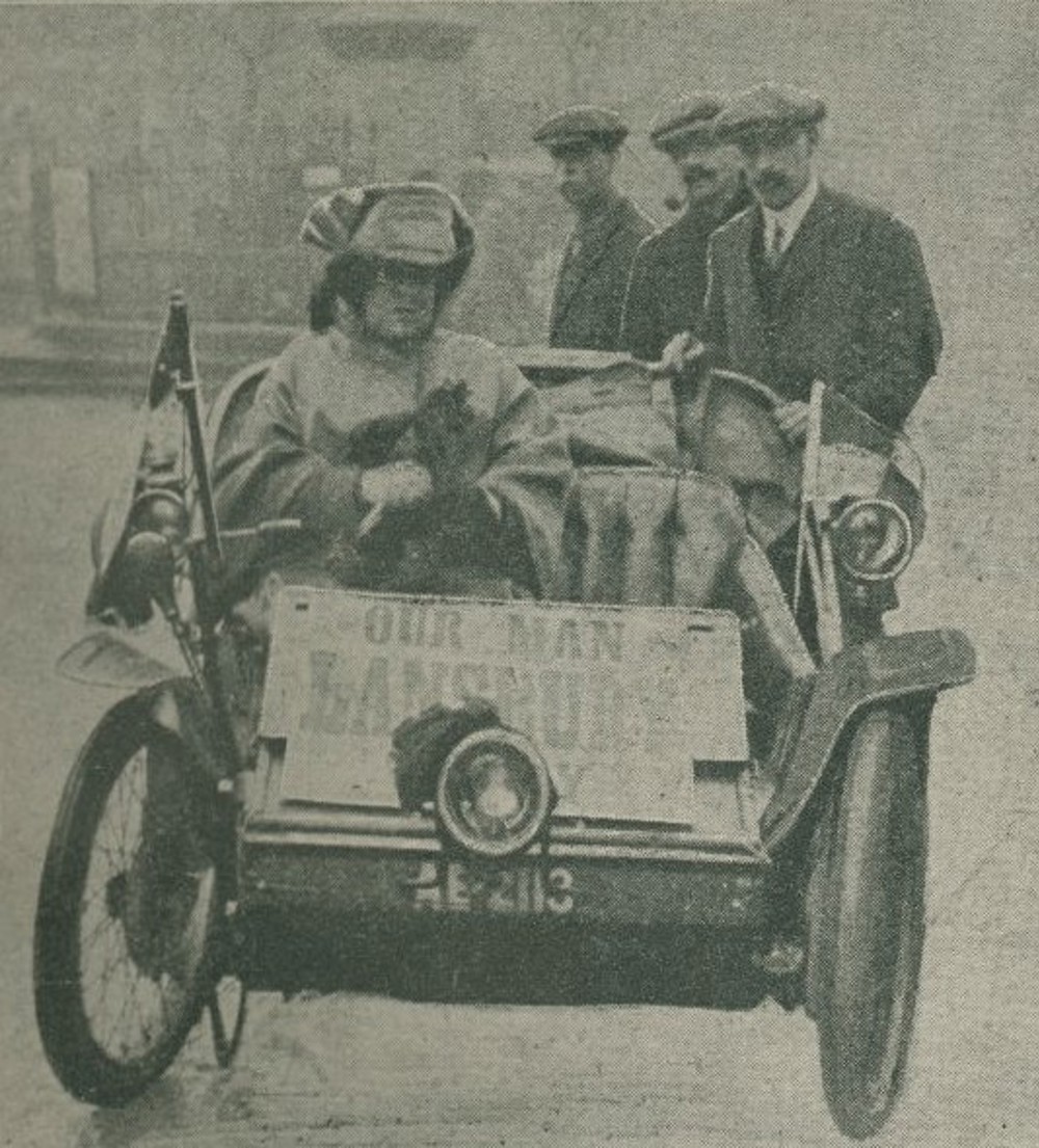 Woman driving a car campaigning for the suffrage cause, image from Cyclecar magazine