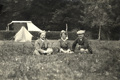 Caravan Club members two men and a woman sitting in the grass in the New Forest