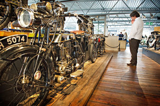 Man looking at vintage motorcycles at the National Motor Museum
