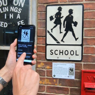 Mobile user scanning a sign with the Smartify app