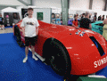 Oliver Segrave standing by the Sunbeam 1000Hp at the British Motor Show