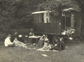 Founder of the Caravan Club J Harris Stone and Club members seated outside a Maisonette caravan