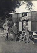 Caravan Club founder J. Harris Stone hands out a delivery of mail from the doorway of his caravan