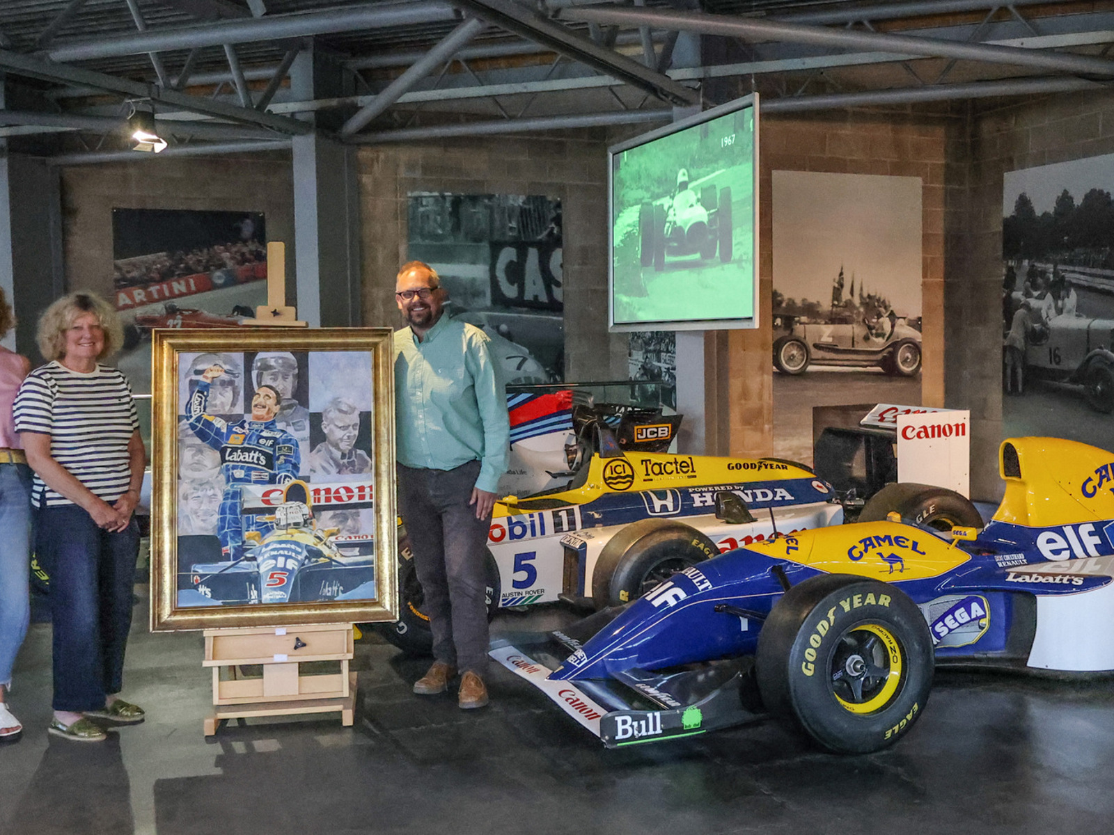 Sara and Lesley Lawrence and Jon Murden with Nigel Mansell Painting