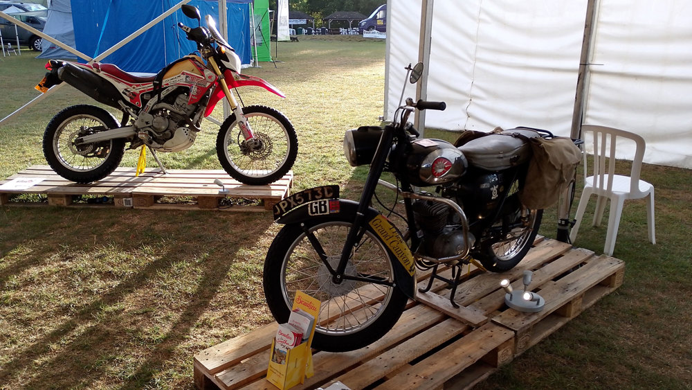 Round The World Motorcycles Mary Sievier's 1965 BSA Bantam With Rhonda The Honda In The Overland Event Bike Display