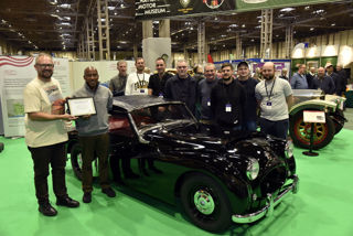 Anthony Hamilton and the 110 Garage restoration team at the National Motor Museum stand at the NEC on Friday 8th November 2024. Anthony Hamilton was presented with a certificate of appreciation by Dr Jon Murden, Chief Executive of the National Motor Museum.