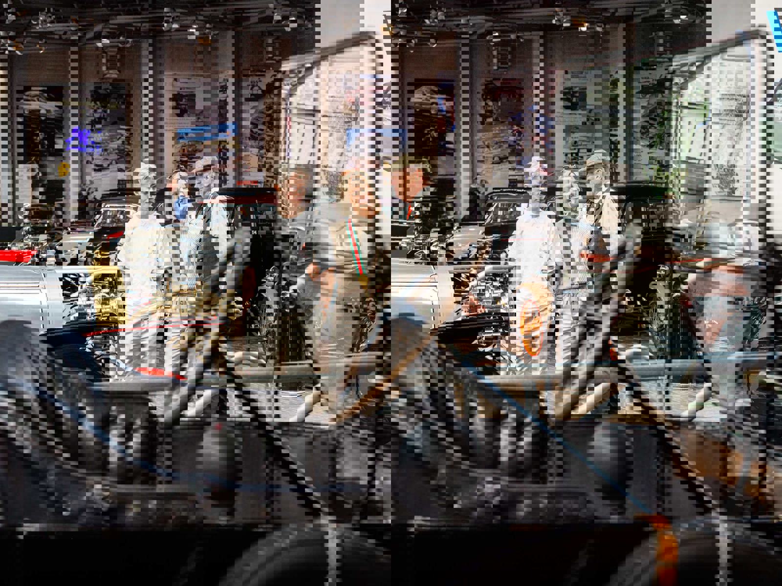 Two female visitors speak to a member of staff in the National Motor Museum