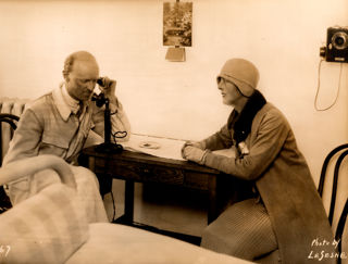 Major Henry Segrave on the phone with his wife Doris Stocker next to him