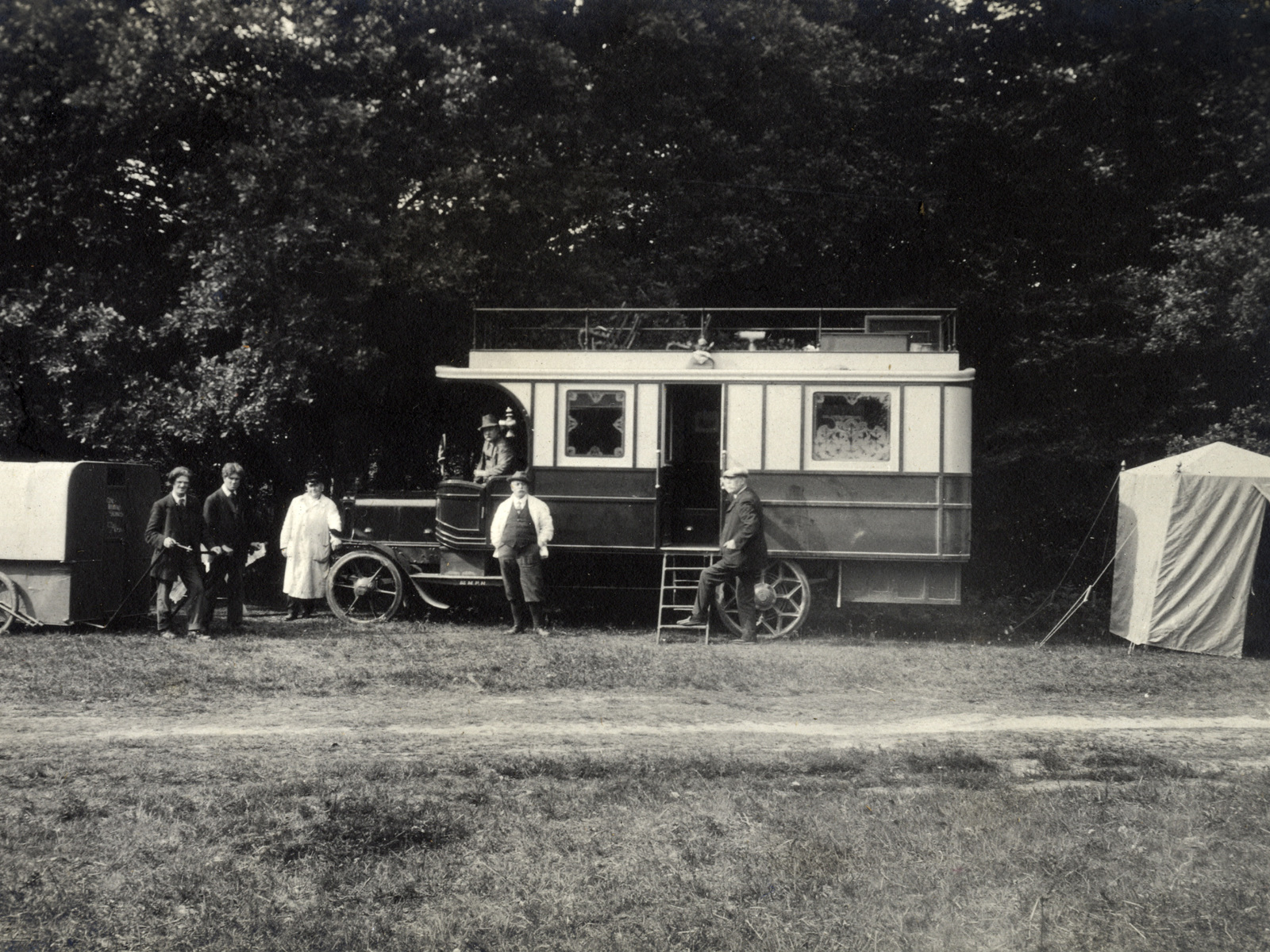 1913 Daimler Chassis Motor Caravan at the Caravan Club meet with men standing around it