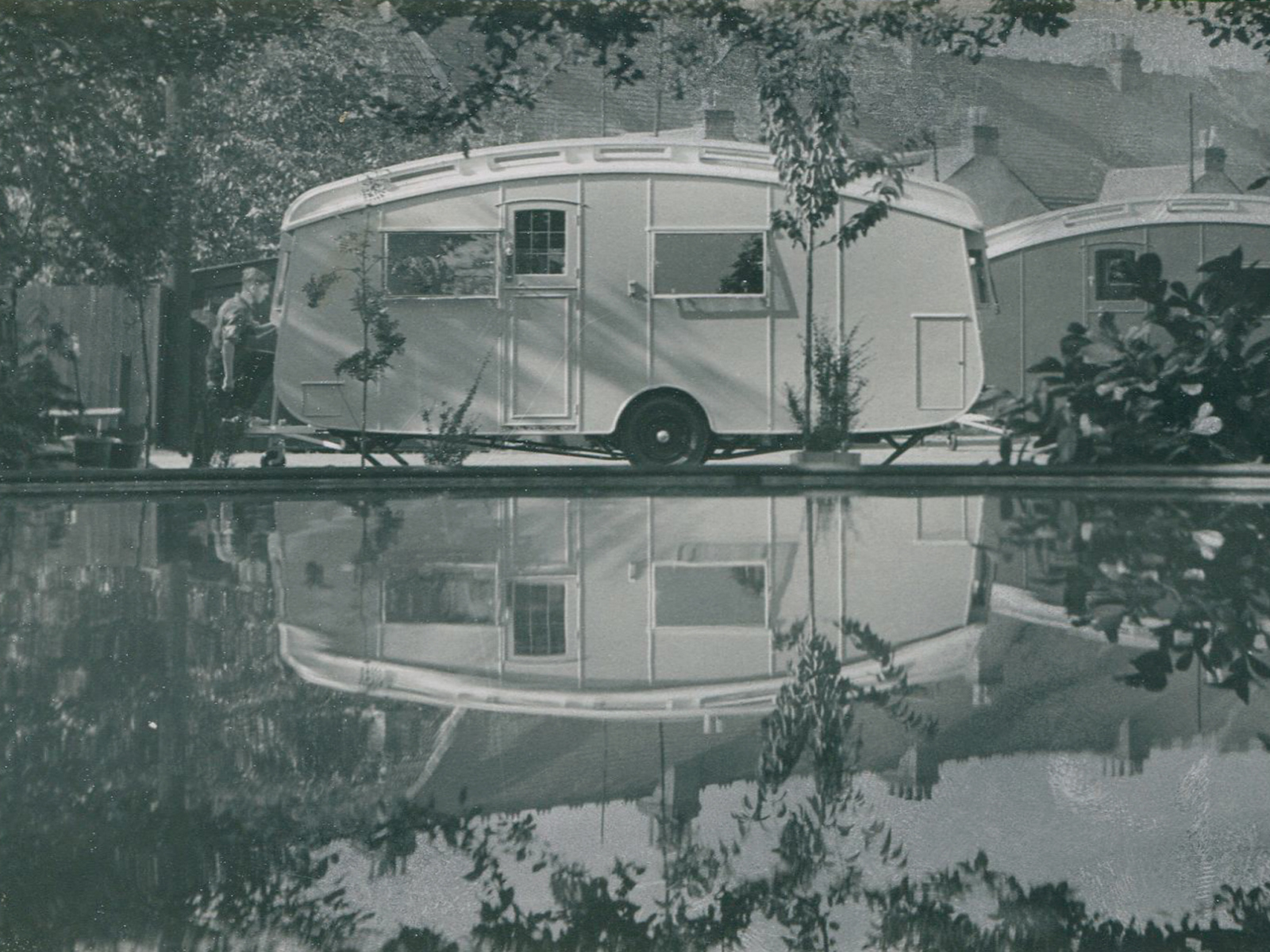 Winchester Royal caravan alongside a boating lake, image is reflected in the water 