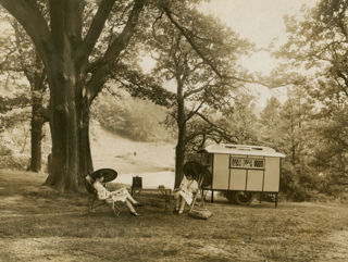 Two women sat by an Eccles caravan in a publicity shot