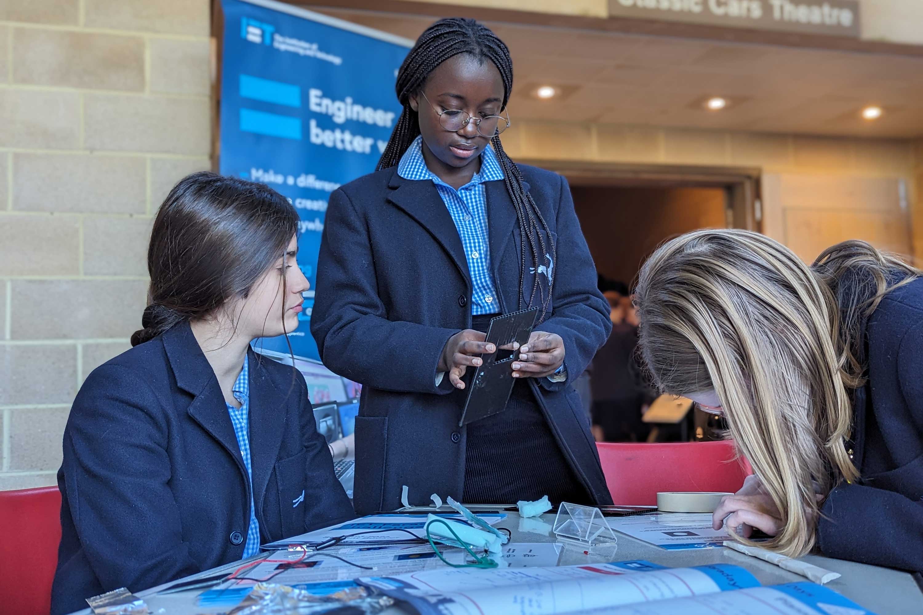 three school girls undertaking an engineering experiment 