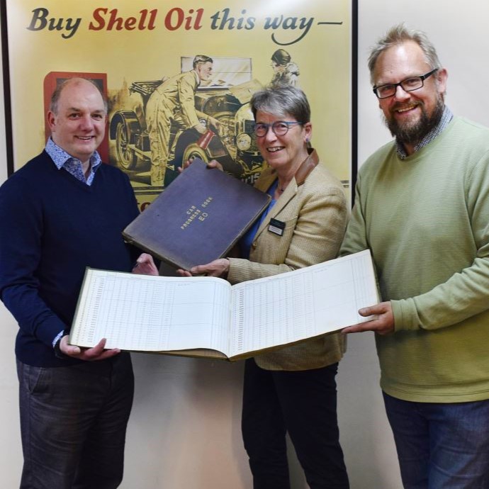 Jon Murden and Andrea Bishop donate record books to Stephen Laing