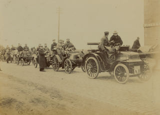 John Montagu sitting in his Daimler, with several other vehicles and drivers, about to leave Edinburgh.