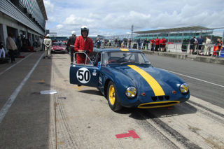 Ivan Dutton standing on a racecourse by his Bugatti