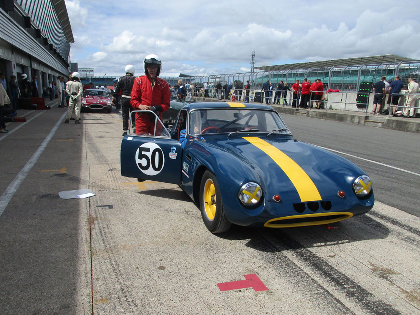 Ivan Dutton standing on a racecourse by his Bugatti