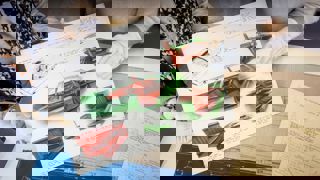 concept car drawings in colour held up by members of staff