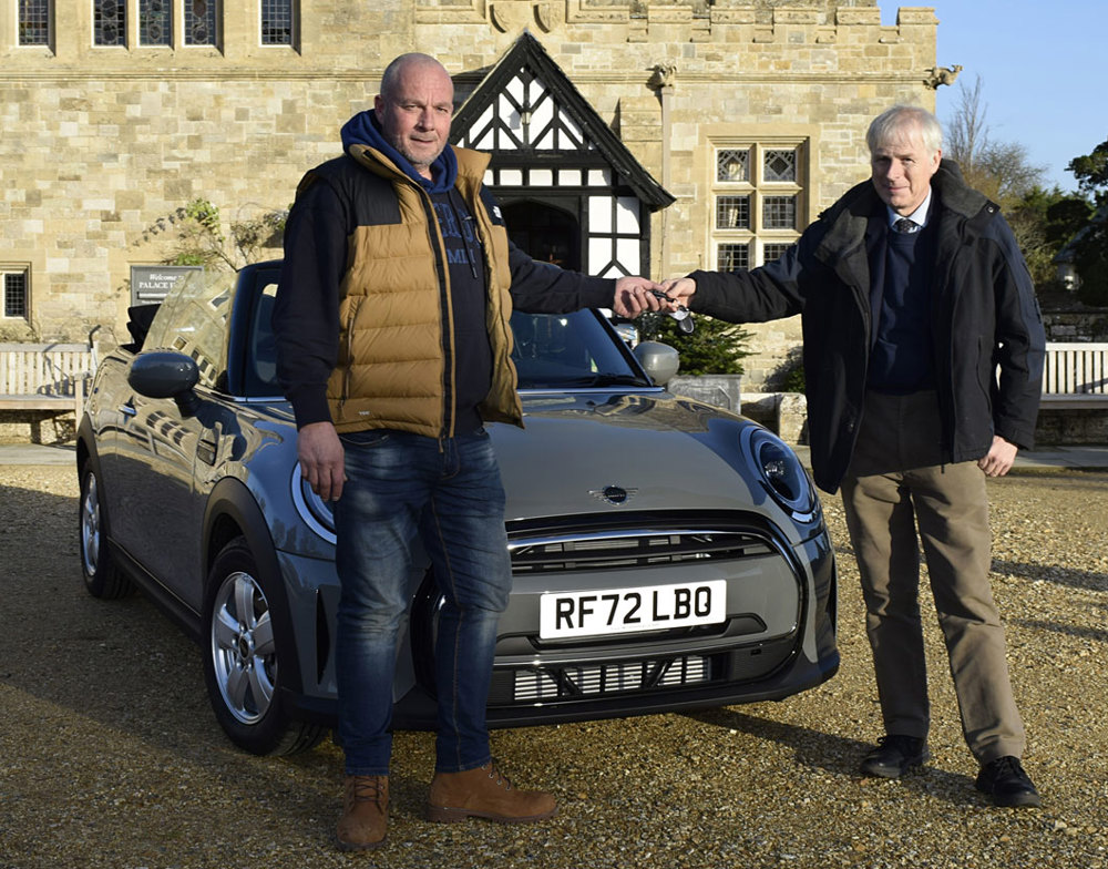 Lord Montagu hands the Mini Cooper keys to Prize Draw Winner 2023 Richard Clothier