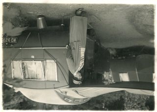 Mrs Fowler next to one of her Eccles Blue Caravans, 1930s