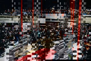 Opening of the National Motor Museum, 1972, large crowds inside museum being addressed by HRH Duke of Kent